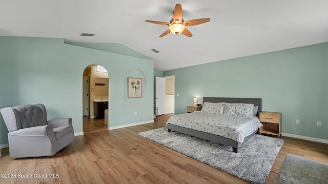 4060 Aria Dr, Melbourne, FL 32904 - bedroom with arched walkways, vaulted ceiling, wood finished floors, and ceiling fan