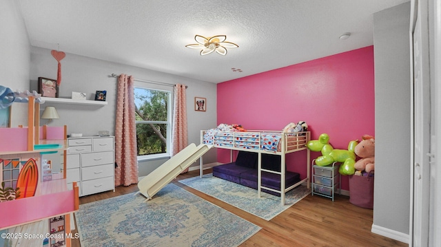 4060 Aria Dr, Melbourne, FL 32904 - bedroom featuring wood finished floors and a textured ceiling