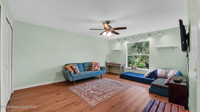 4060 Aria Dr, Melbourne, FL 32904 - sitting room with ceiling fan, wood finished floors, rail lighting, and a textured ceiling