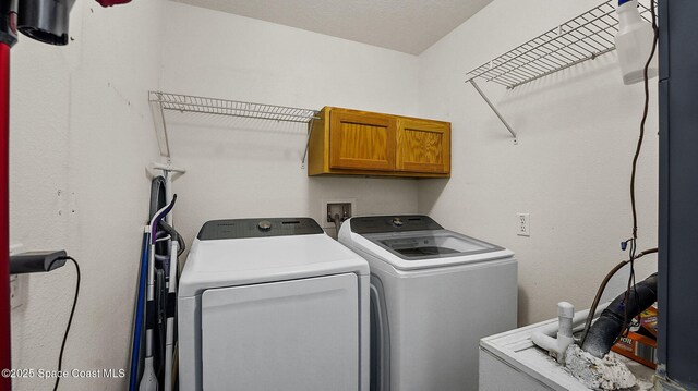 4060 Aria Dr, Melbourne, FL 32904 - laundry area featuring washing machine and dryer and cabinet space