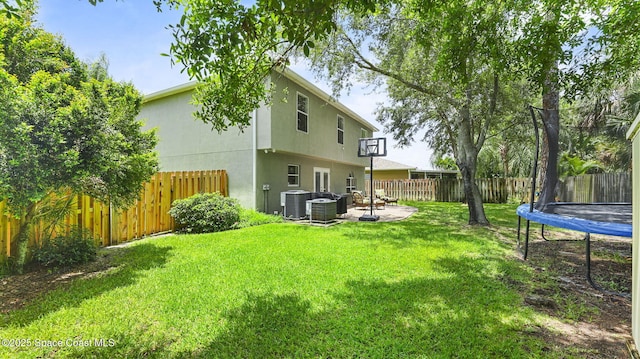 4060 Aria Dr, Melbourne, FL 32904 - fenced backyard featuring a trampoline and a patio