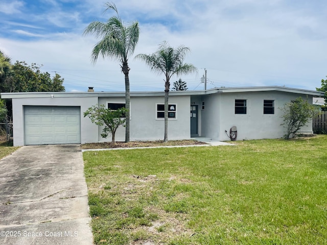 235 NE 2nd St, Satellite Beach, FL 32937 - view of front of property featuring stucco siding, driveway, a front yard, and a garage