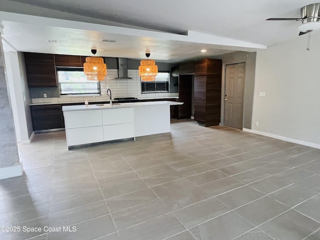 235 NE 2nd St, Satellite Beach, FL 32937 - kitchen featuring wall chimney exhaust hood, modern cabinets, light countertops, and recessed lighting