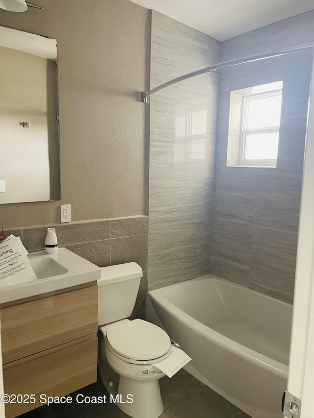 235 NE 2nd St, Satellite Beach, FL 32937 - bathroom with vanity, tub / shower combination, and tile walls