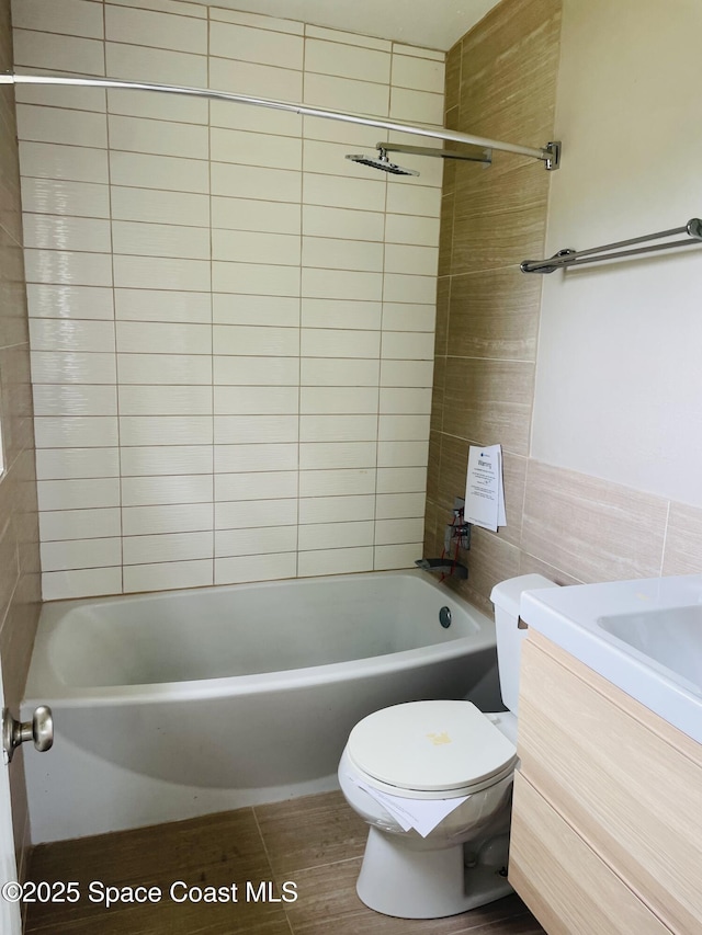 235 NE 2nd St, Satellite Beach, FL 32937 - bathroom featuring vanity, shower / washtub combination, and tile walls