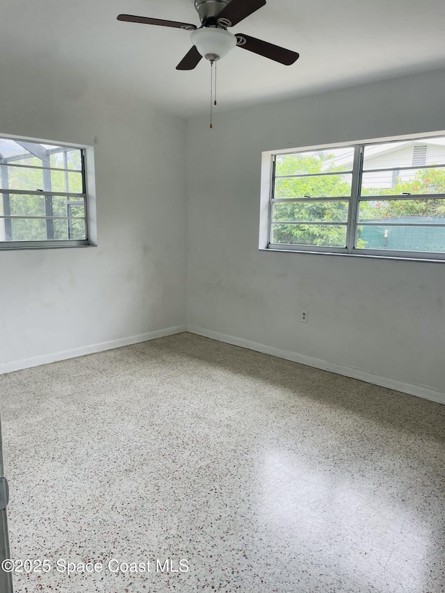 235 NE 2nd St, Satellite Beach, FL 32937 - spare room with speckled floor and ceiling fan