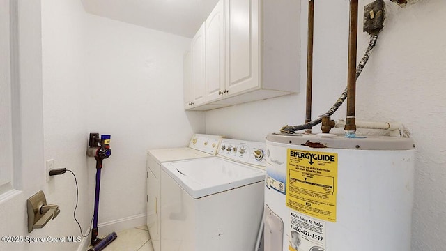 210 Cleveland Ave Unit 210, Cocoa Beach, FL 32931 - laundry room with water heater, cabinet space, washing machine and clothes dryer, and light tile patterned floors