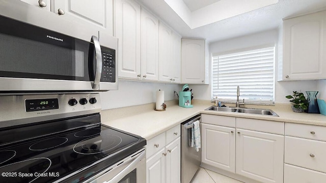 210 Cleveland Ave Unit 210, Cocoa Beach, FL 32931 - kitchen featuring appliances with stainless steel finishes, white cabinetry, and light countertops