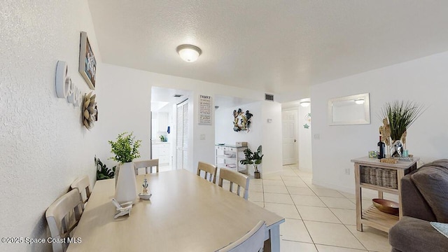 210 Cleveland Ave Unit 210, Cocoa Beach, FL 32931 - dining space featuring light tile patterned floors and a textured ceiling