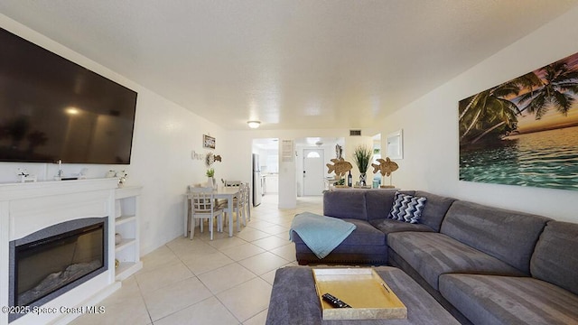 210 Cleveland Ave Unit 210, Cocoa Beach, FL 32931 - living area featuring light tile patterned floors and a glass covered fireplace