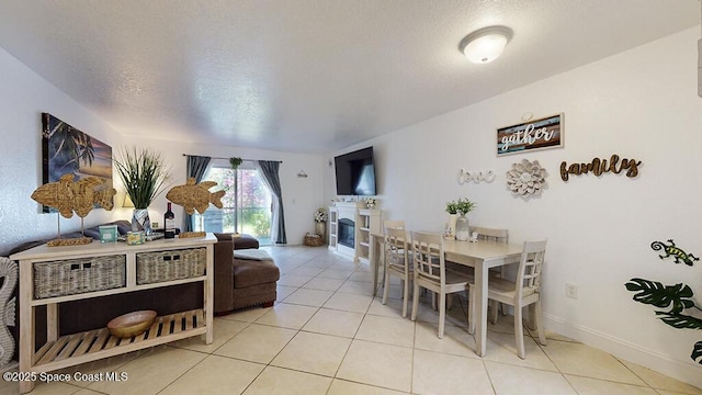 210 Cleveland Ave Unit 210, Cocoa Beach, FL 32931 - tiled dining space featuring a fireplace and a textured ceiling
