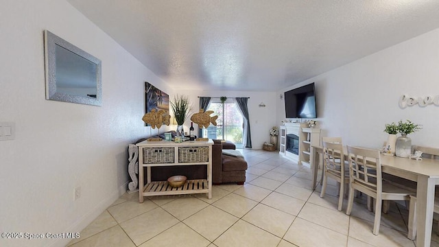 210 Cleveland Ave Unit 210, Cocoa Beach, FL 32931 - living area featuring light tile patterned floors and a glass covered fireplace