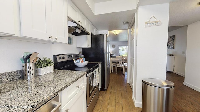 212 Cleveland Ave Unit 212, Cocoa Beach, FL 32931 - kitchen with appliances with stainless steel finishes, under cabinet range hood, white cabinetry, and wood finished floors