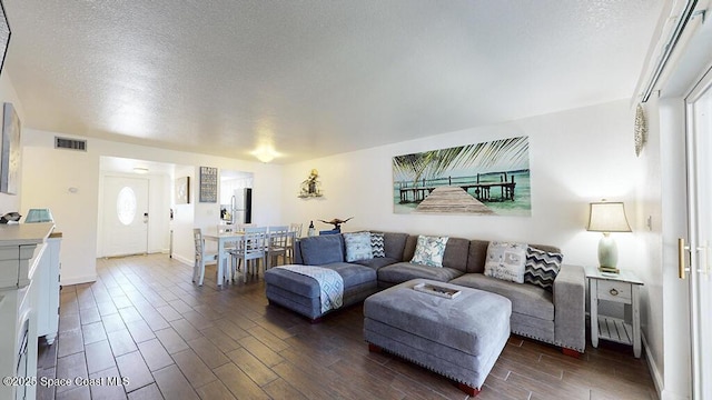 212 Cleveland Ave Unit 212, Cocoa Beach, FL 32931 - living room featuring dark wood-style floors, a textured ceiling, and plenty of natural light