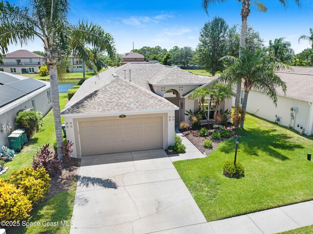 1137 White Oak Cir, Melbourne, FL 32934 - view of front facade featuring a shingled roof, stucco siding, driveway, a garage, and a front lawn