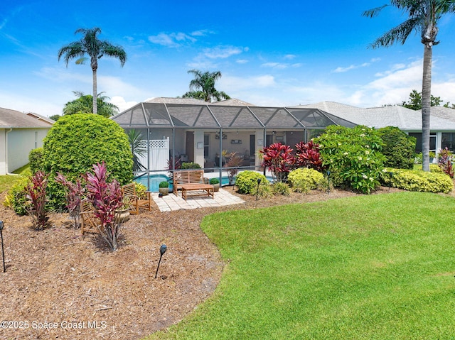 1137 White Oak Cir, Melbourne, FL 32934 - rear view of property with a patio, a lawn, an outdoor pool, and a lanai