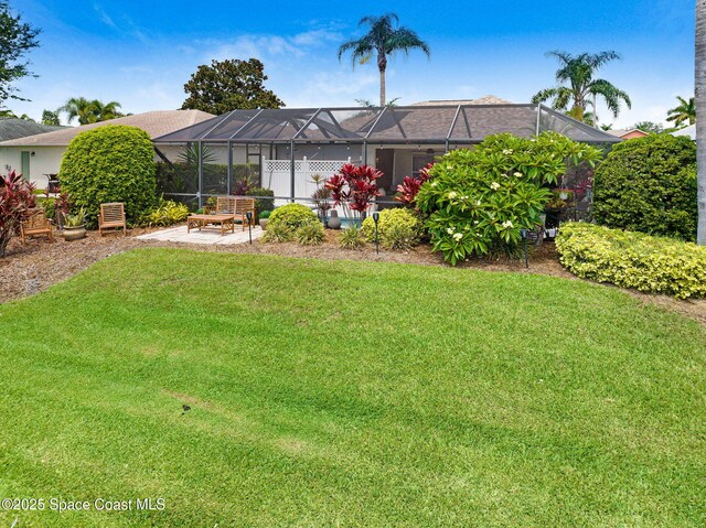 1137 White Oak Cir, Melbourne, FL 32934 - back of property featuring a lawn, a patio area, and a lanai