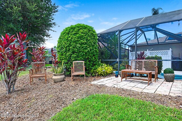 1137 White Oak Cir, Melbourne, FL 32934 - view of yard featuring a patio and glass enclosure