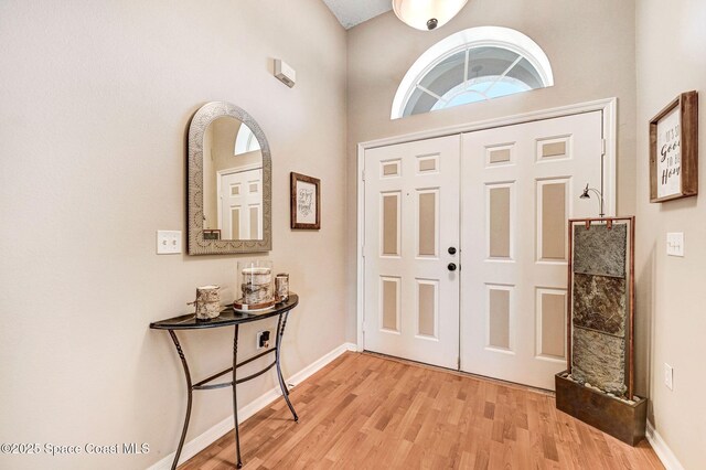 1137 White Oak Cir, Melbourne, FL 32934 - entryway featuring light wood finished floors and baseboards