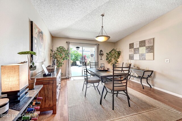 1137 White Oak Cir, Melbourne, FL 32934 - dining area featuring wood finished floors and a textured ceiling