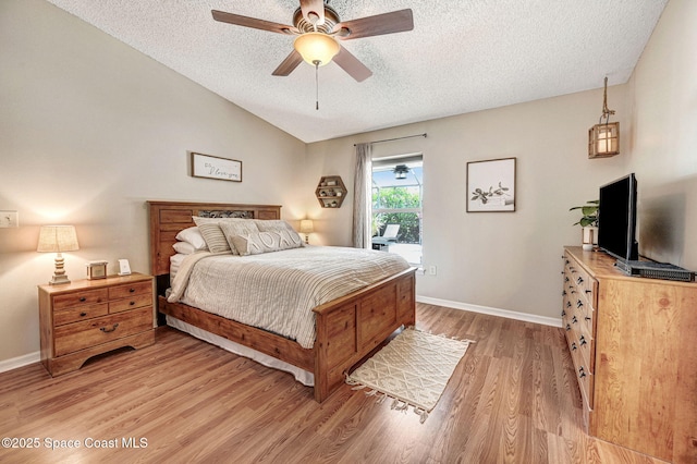 1137 White Oak Cir, Melbourne, FL 32934 - bedroom with a textured ceiling, light wood finished floors, lofted ceiling, access to exterior, and ceiling fan