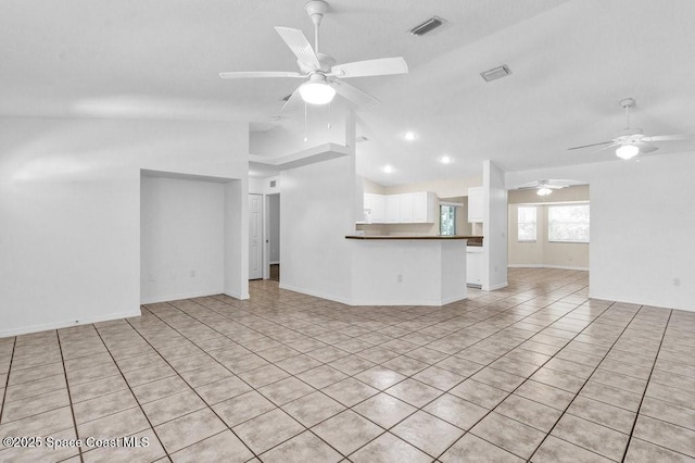 461 Coply Ter, Sebastian, FL 32958 - unfurnished living room with vaulted ceiling, a ceiling fan, and light tile patterned flooring
