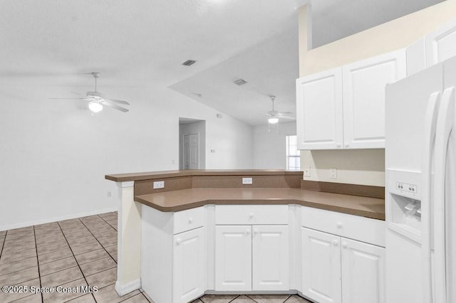461 Coply Ter, Sebastian, FL 32958 - kitchen with white refrigerator with ice dispenser, ceiling fan, vaulted ceiling, a peninsula, and dark countertops
