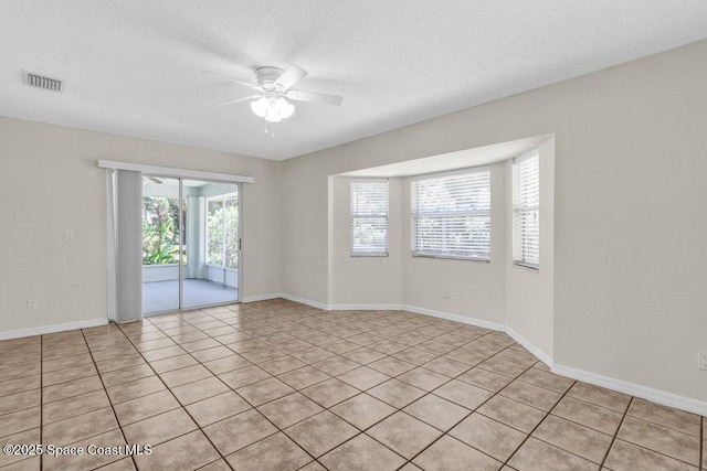 461 Coply Ter, Sebastian, FL 32958 - empty room with a ceiling fan, light tile patterned floors, and a textured ceiling