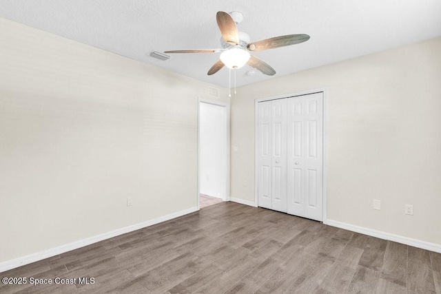 461 Coply Ter, Sebastian, FL 32958 - unfurnished bedroom with wood finished floors, a closet, and a ceiling fan