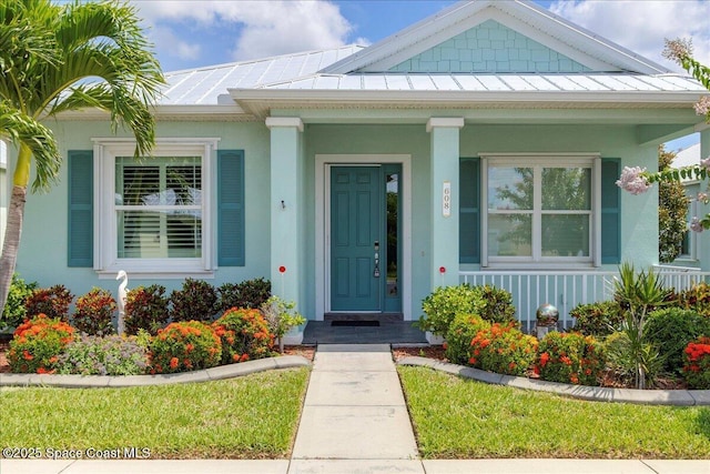 608 Lorelei Ave, Melbourne, FL 32901 - doorway to property with a standing seam roof, covered porch, and a metal roof