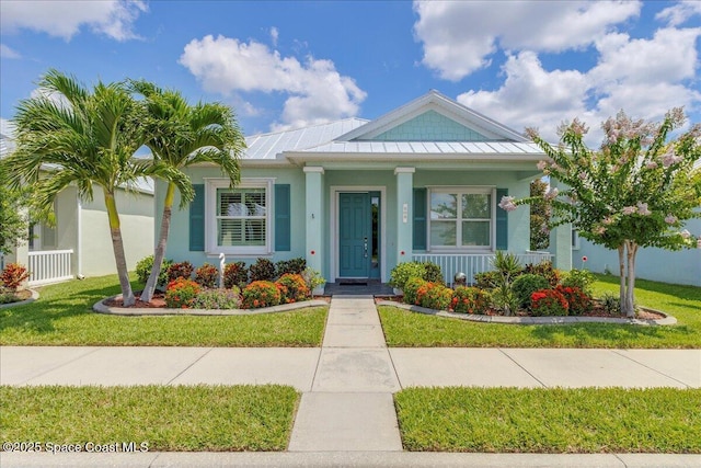 608 Lorelei Ave, Melbourne, FL 32901 - view of front of property featuring a standing seam roof, a porch, a metal roof, and a front yard