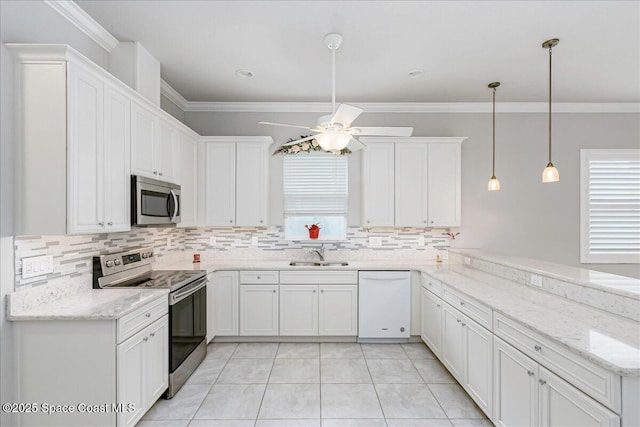 608 Lorelei Ave, Melbourne, FL 32901 - kitchen with stainless steel appliances, a ceiling fan, tasteful backsplash, a peninsula, and crown molding