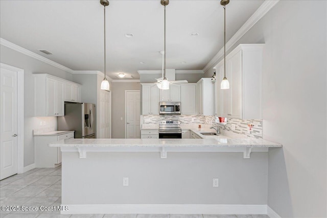 608 Lorelei Ave, Melbourne, FL 32901 - kitchen featuring stainless steel appliances, a peninsula, decorative backsplash, white cabinets, and ceiling fan