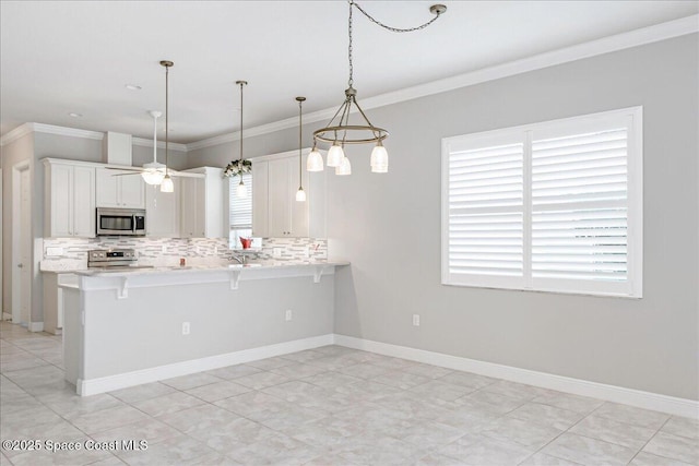 608 Lorelei Ave, Melbourne, FL 32901 - kitchen with appliances with stainless steel finishes, decorative backsplash, light countertops, crown molding, and plenty of natural light