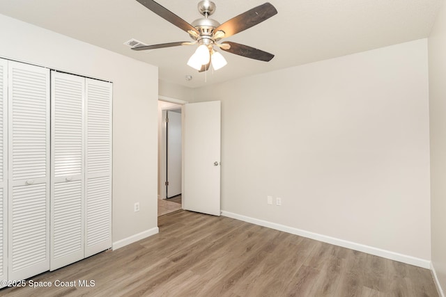1337 Pakenham St NW, Palm Bay, FL 32907 - unfurnished bedroom featuring light wood-style floors, a closet, and a ceiling fan