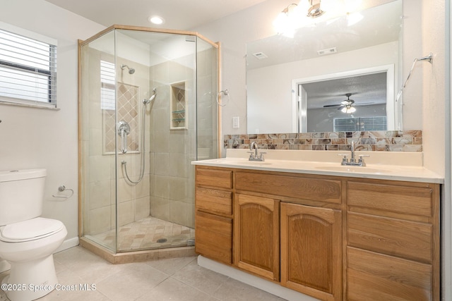 1337 Pakenham St NW, Palm Bay, FL 32907 - full bathroom with double vanity, a stall shower, tile patterned flooring, tasteful backsplash, and a ceiling fan