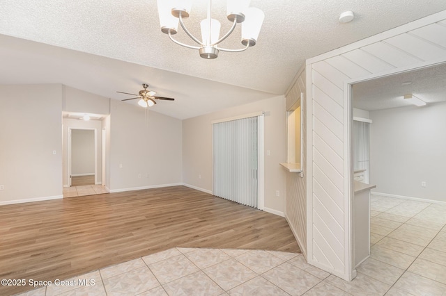 1337 Pakenham St NW, Palm Bay, FL 32907 - unfurnished room with lofted ceiling, a chandelier, a textured ceiling, ceiling fan, and light wood-type flooring