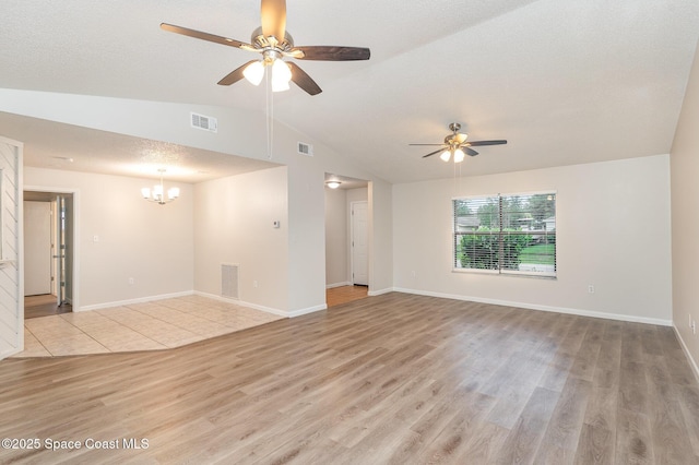 1337 Pakenham St NW, Palm Bay, FL 32907 - unfurnished room with lofted ceiling, light wood-type flooring, ceiling fan, and a chandelier