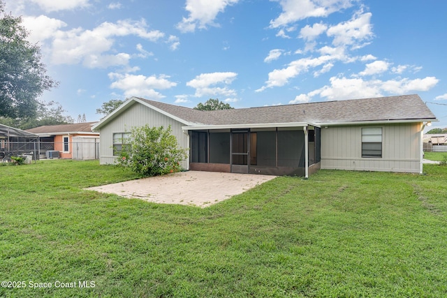 1337 Pakenham St NW, Palm Bay, FL 32907 - back of house with a sunroom, roof with shingles, and a patio