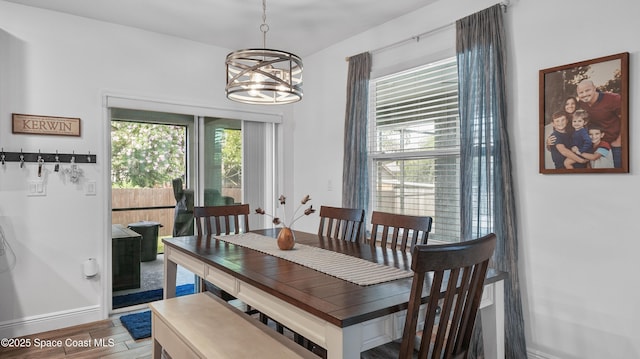 6830 Harp Ave, Cocoa, FL 32927 - dining room with a chandelier and wood finished floors