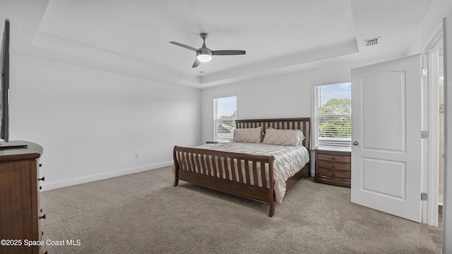 6830 Harp Ave, Cocoa, FL 32927 - carpeted bedroom with a tray ceiling and ceiling fan