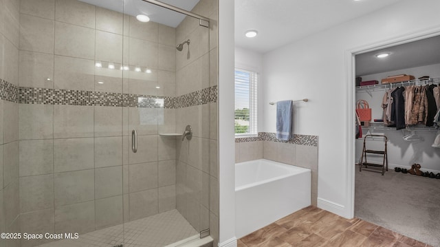 6830 Harp Ave, Cocoa, FL 32927 - bathroom featuring a garden tub, a shower stall, and a walk in closet