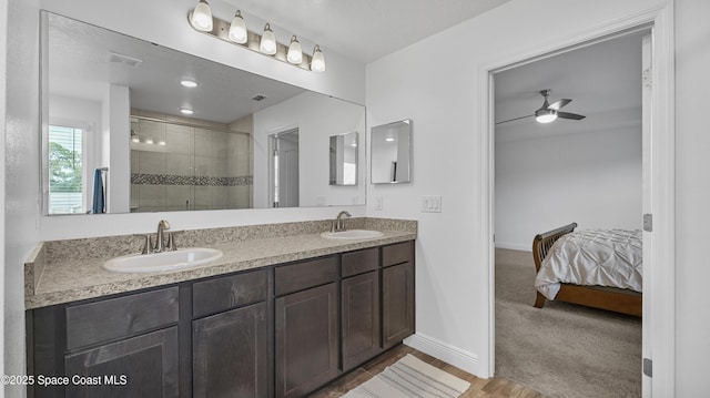 6830 Harp Ave, Cocoa, FL 32927 - bathroom with a shower stall, double vanity, ensuite bathroom, a ceiling fan, and wood finished floors