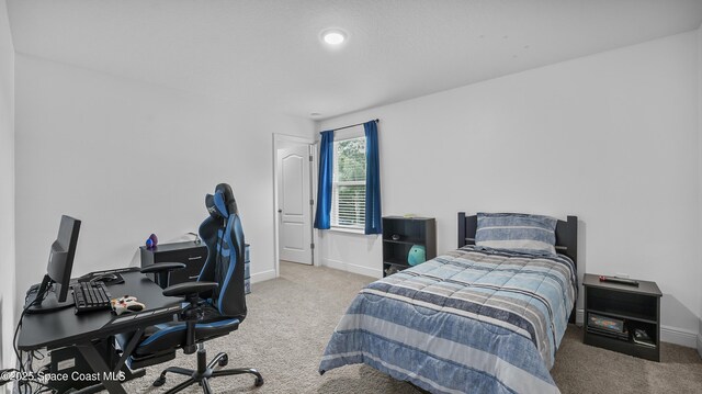 6830 Harp Ave, Cocoa, FL 32927 - carpeted bedroom featuring a desk and baseboards
