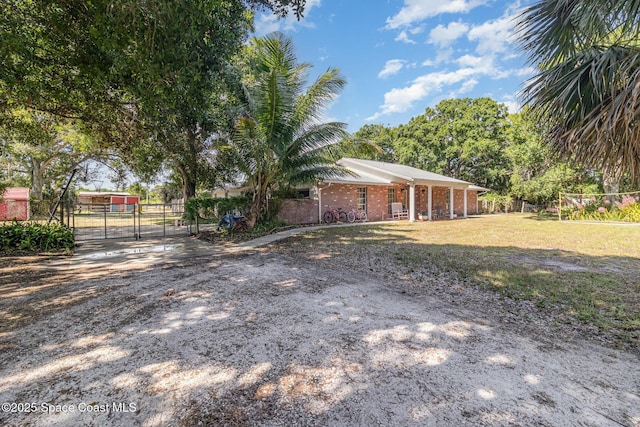 4685 Sand Point Rd, Grant, FL 32949 - view of property exterior with a gate and brick siding