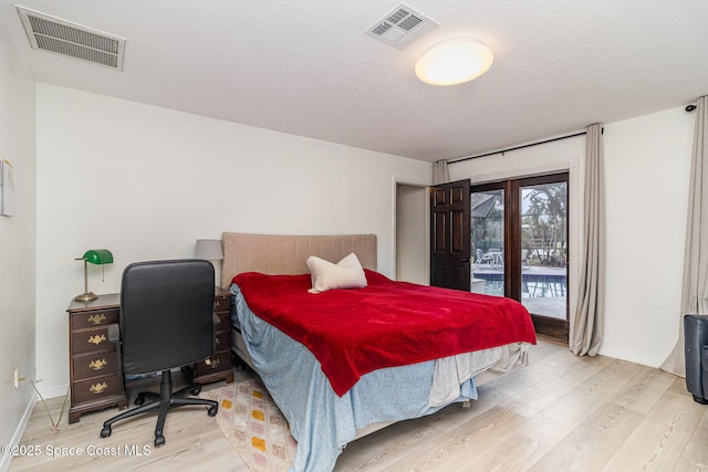 4685 Sand Point Rd, Grant, FL 32949 - bedroom featuring access to outside, wood finished floors, and a textured ceiling