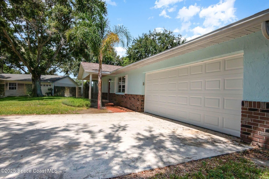 872 Bartel Ct, Rockledge, FL 32955 - ranch-style home with brick siding, an attached garage, driveway, and a front lawn