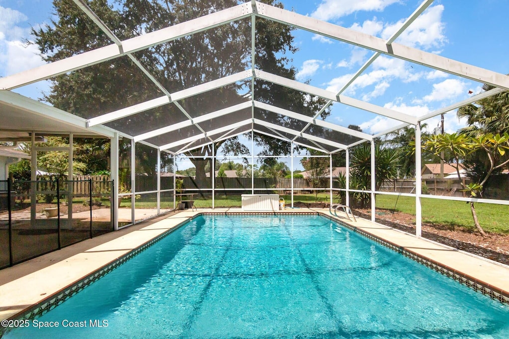 872 Bartel Ct, Rockledge, FL 32955 - outdoor pool featuring a fenced backyard, glass enclosure, and a patio