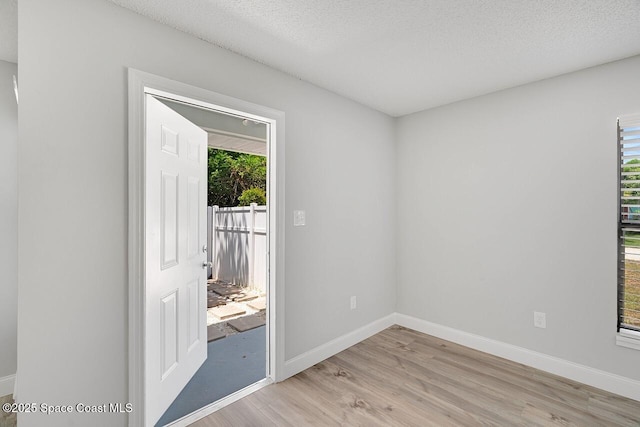 1256 16th Ave SW, Vero Beach, FL 32962 - spare room with light wood-type flooring and a textured ceiling