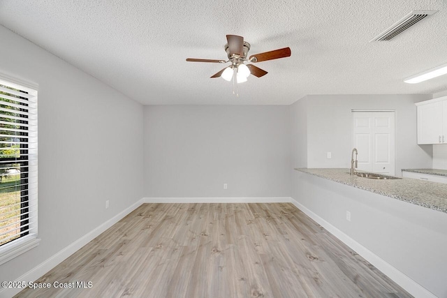 1256 16th Ave SW, Vero Beach, FL 32962 - empty room featuring a ceiling fan, light wood finished floors, and a textured ceiling